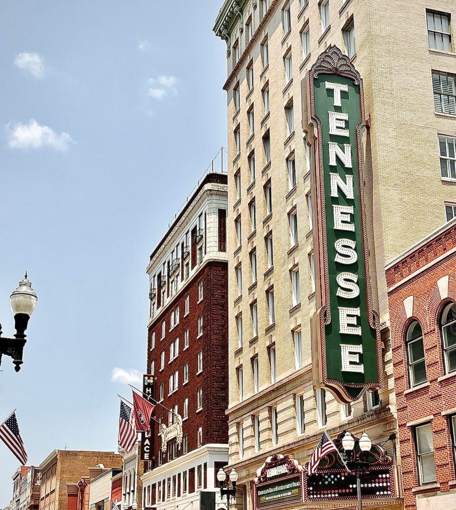 brown concrete building with green and white signage